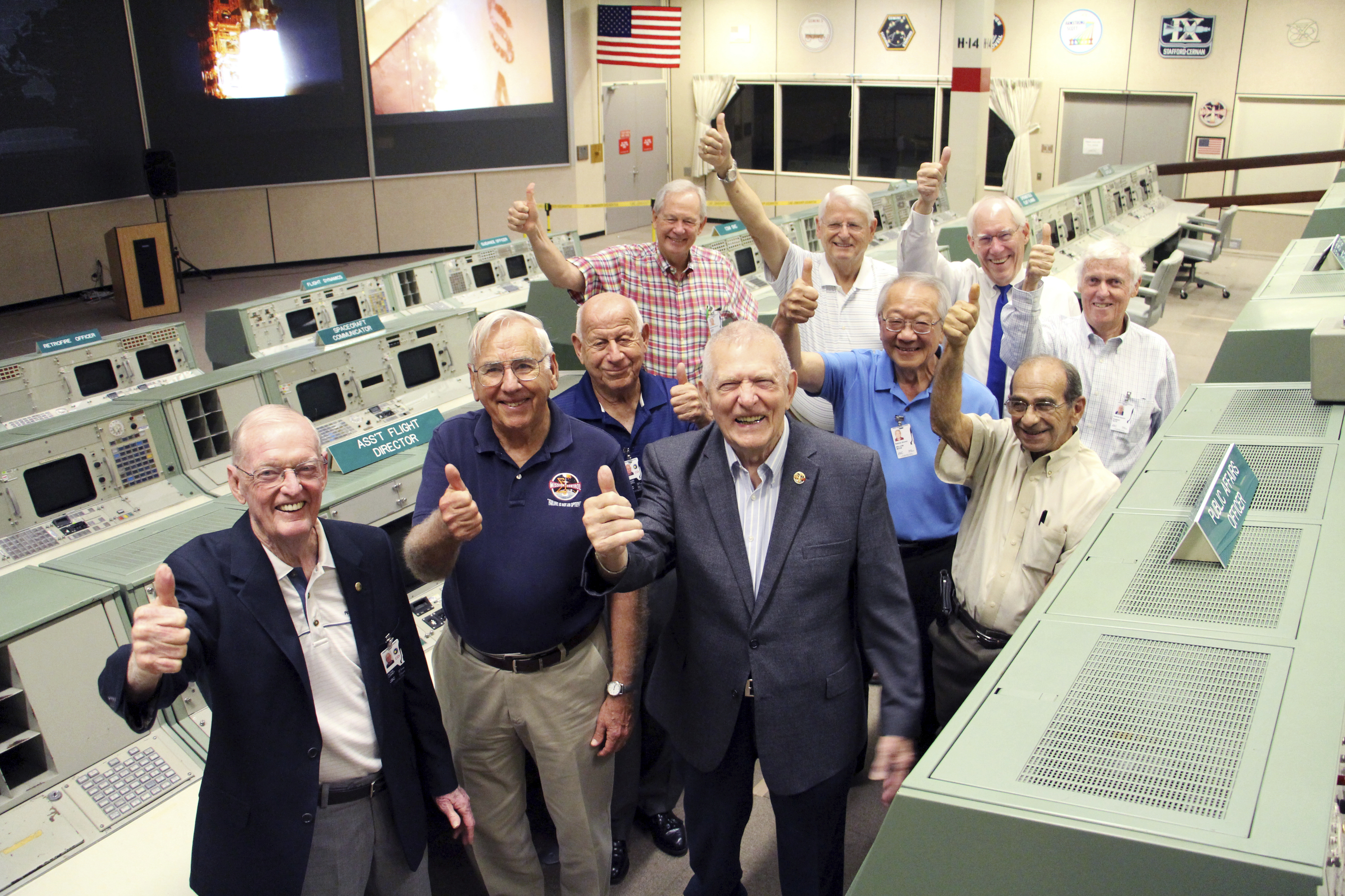 Retired NASA officials led by Apollo 11 flight director Gene Kranz (center), celebrate the end of a Kickstarter drive that saw Space Center Houston raise nearly $507,000 to help restore Mission Control, the historic facility from where NASA monitored space flights during the Apollo era.