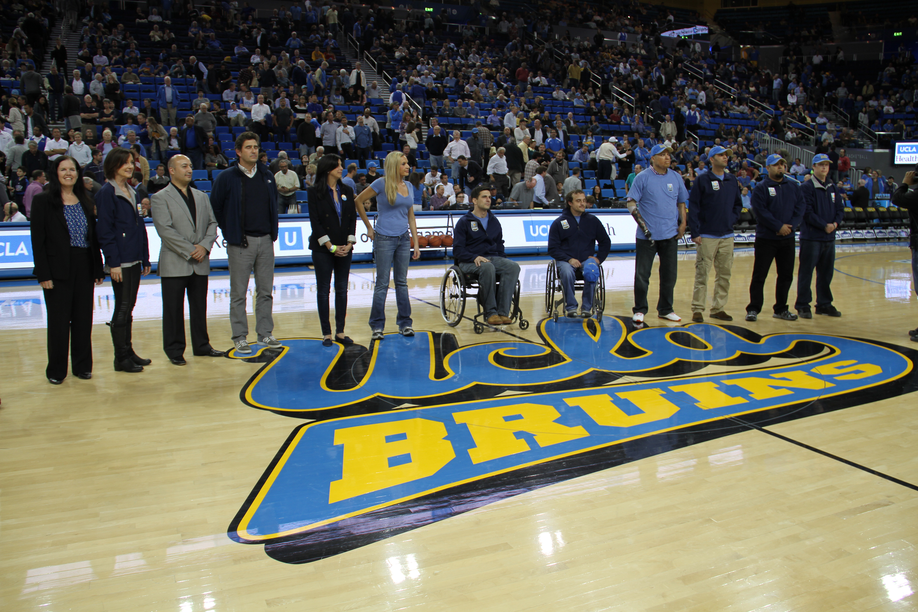 Dr. Hame, Dr. Sornborger, Dr. Azari, Dr. Crisera, Dana Katz, Melanie Gideo with patients at a UCLA basketball game where Operation Mend was recognized.