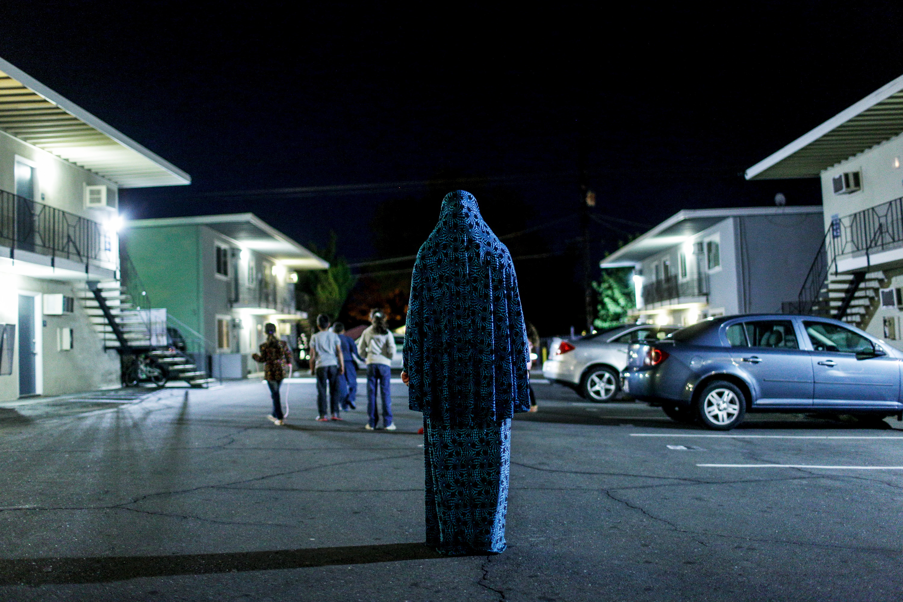 A Syrian woman poses outside the Sacramento apartment complex where she lives after fleeing her home country’s civil war. The California Endowment granted more than $300,000 to the International Rescue Committee to resettle Syrian refugees in the state.