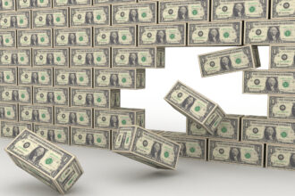 A 3D image of a wall made of US one-dollar bills, with several blocks falling from the right side, suggesting construction.