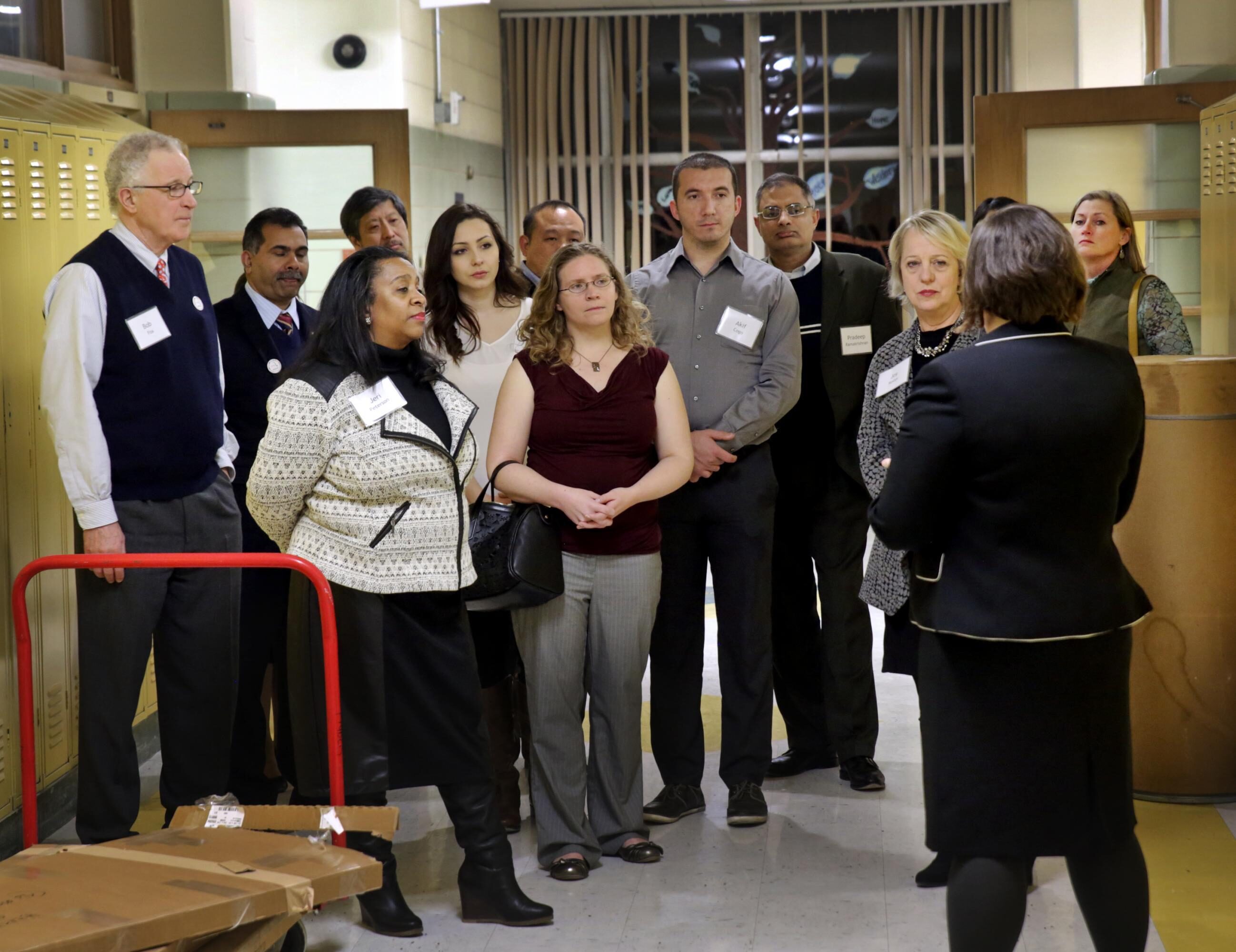 Bob Fox, on left, takes part in a tour of the new campus of the International Institute of St. Louis, where refugees and immigrants take classes on citizenship, entrepreneurship, and job skills.