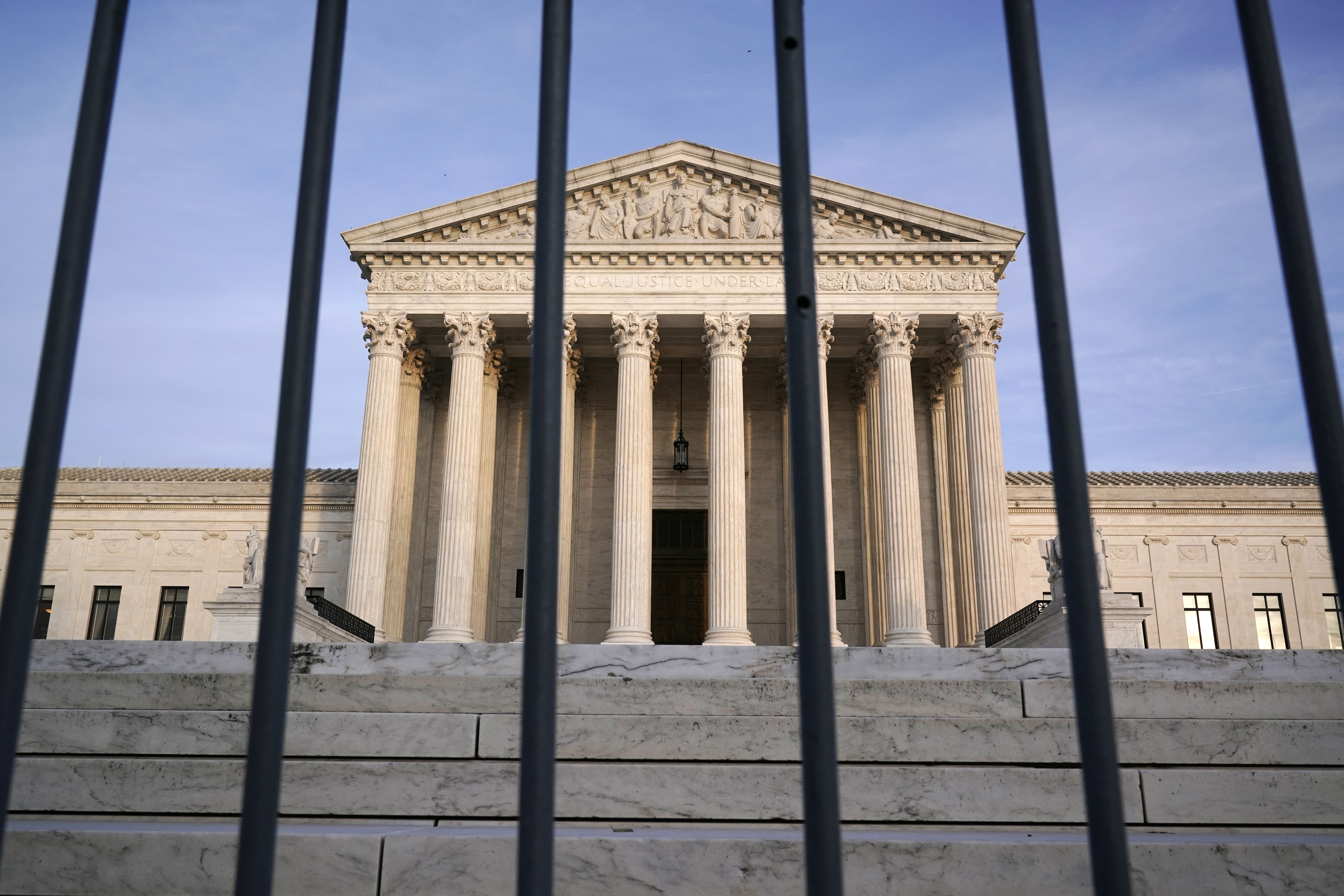 The Supreme Court is seen through a security fence in Washington, Thursday afternoon, Nov. 5, 2020.