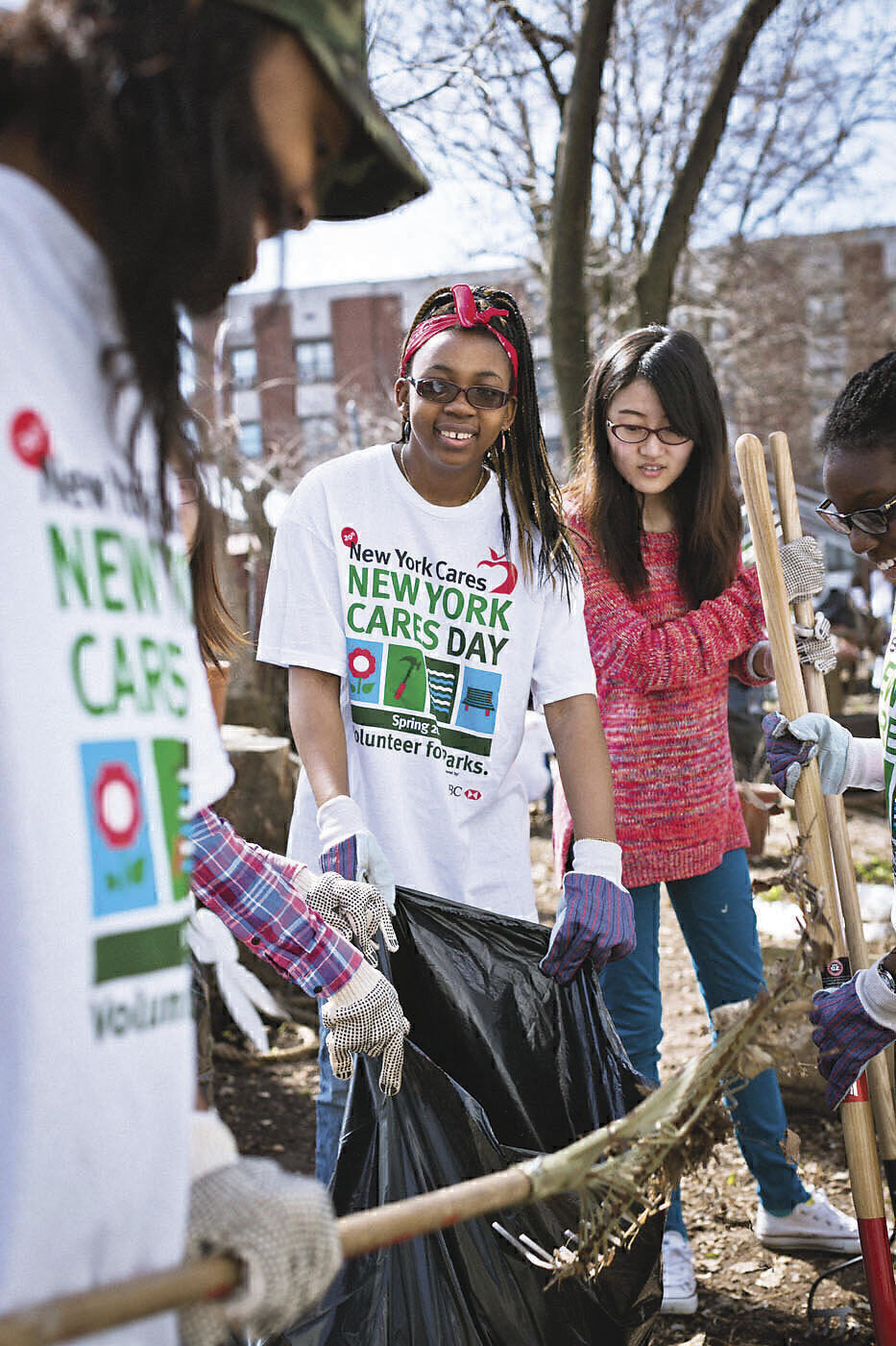 Youth volunteers rake leaves at Hattie Carthan Community Garden in Brooklyn.
