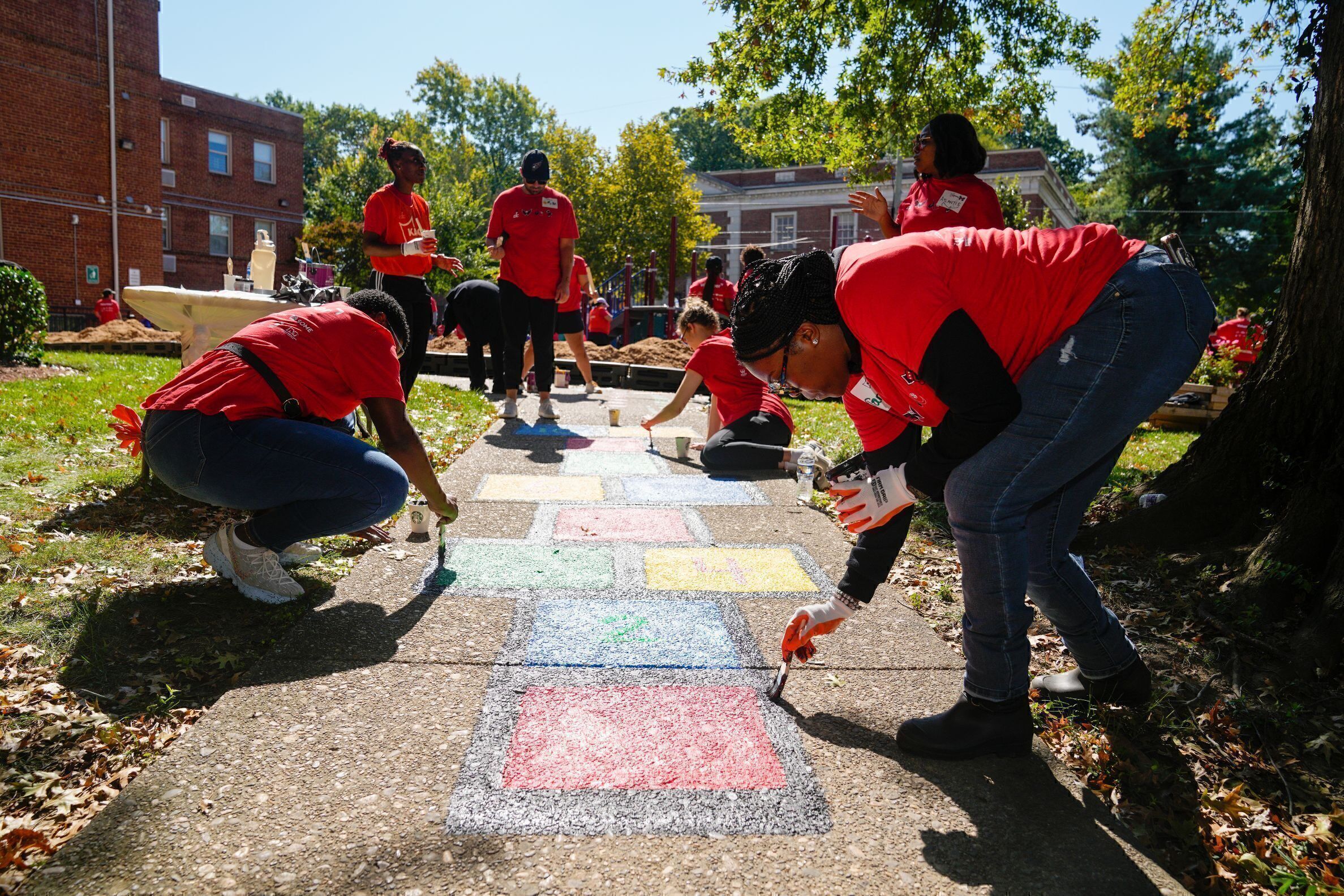 Volunteers work on a new playground and common space at Independence Place, a low-income housing community run by So Others Might Eat, in Washington, D.C., on Sept. 19, 2023.