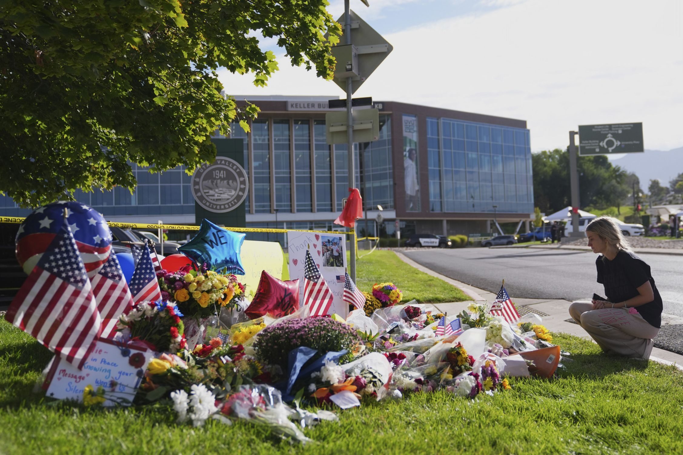 Meagan Bradley kneels at a memorial is set up for Charlie Kirk at Utah Valley University in Orem, Utah, Friday, Sept. 12, 2025.