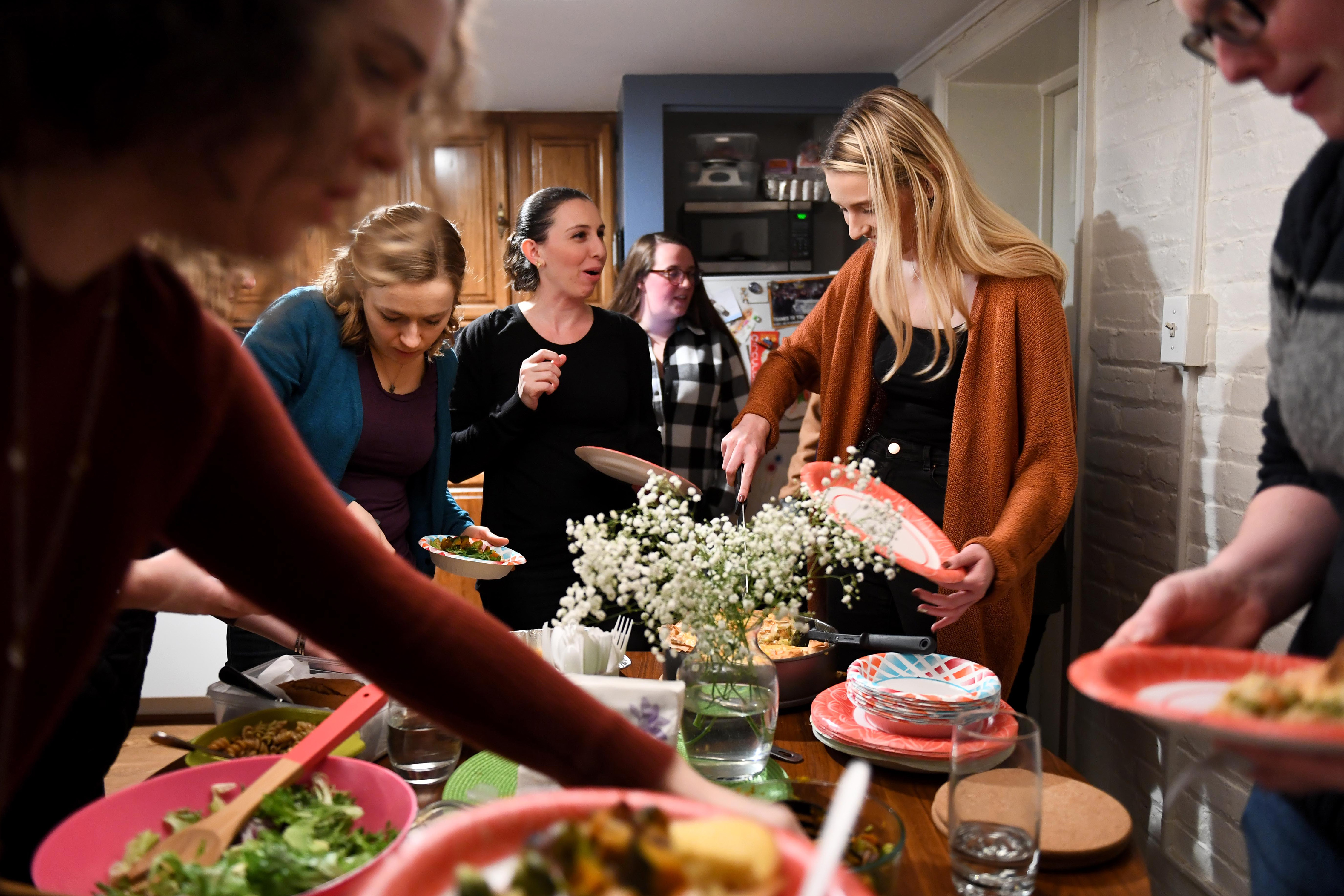 WASHINGTON, DC - A dozen women gather together at "The Dinner Party" November 11, 2018 in Washington, DC. The Dinner Party, a community of mostly 20/30-somethings who have experienced significant loss, gather at potluck dinners to talk about their grief and their experiences. It's a national program. (Katherine Frey, The Washington Post, Getty Images)