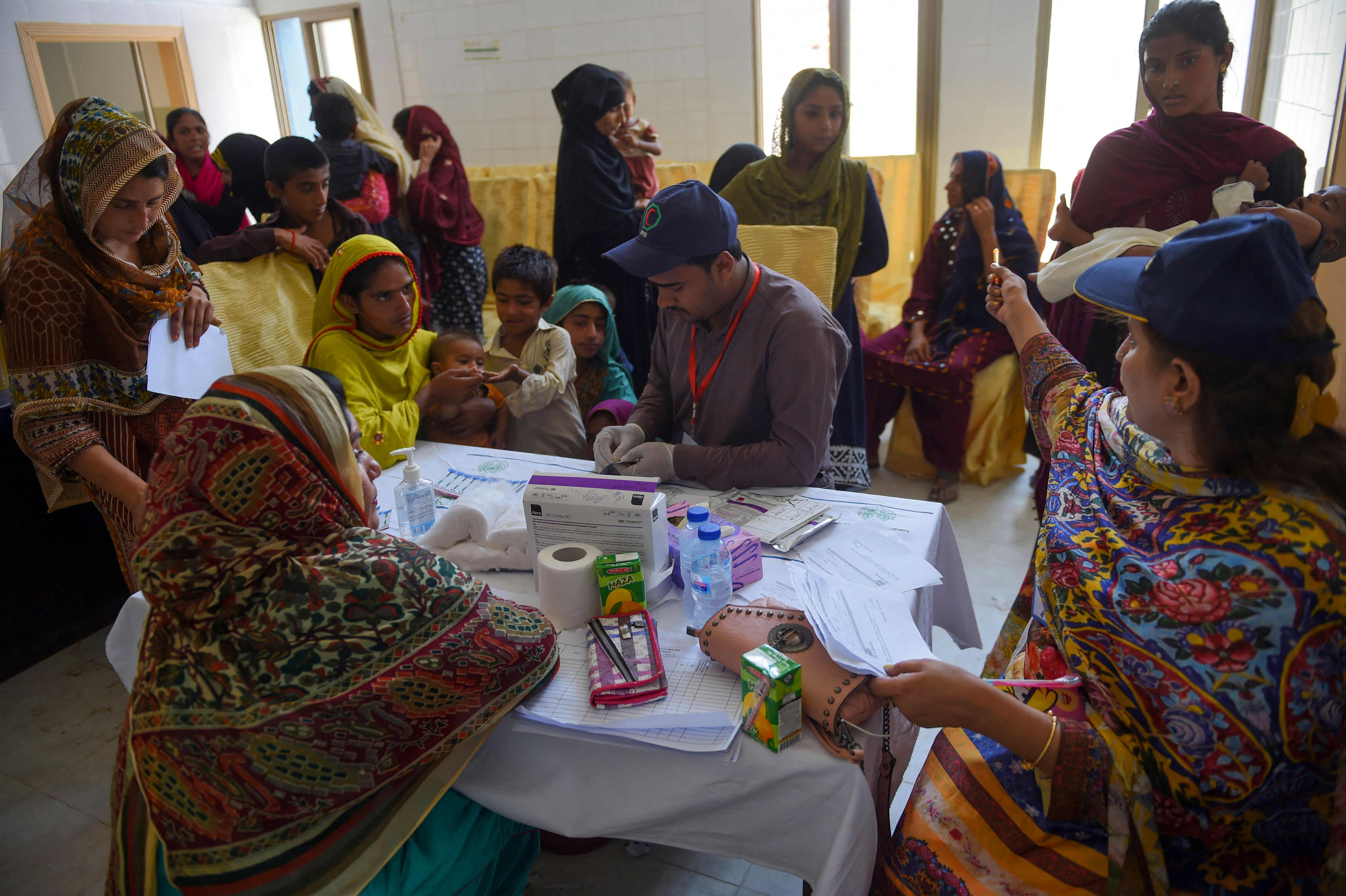 Pakistani paramedics take blood samples from children for HIV tests at a state-run hospital in Rato Dero in the district of Larkana of the southern Sindh province in 2019. 