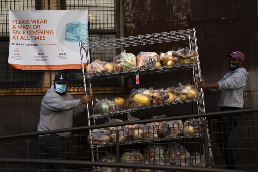 Volunteers package and distribute food for those in need at the New York Common Pantry on 109th Street, Wednesday, Dec. 1, 2021, in the Manhattan borough of New York.
