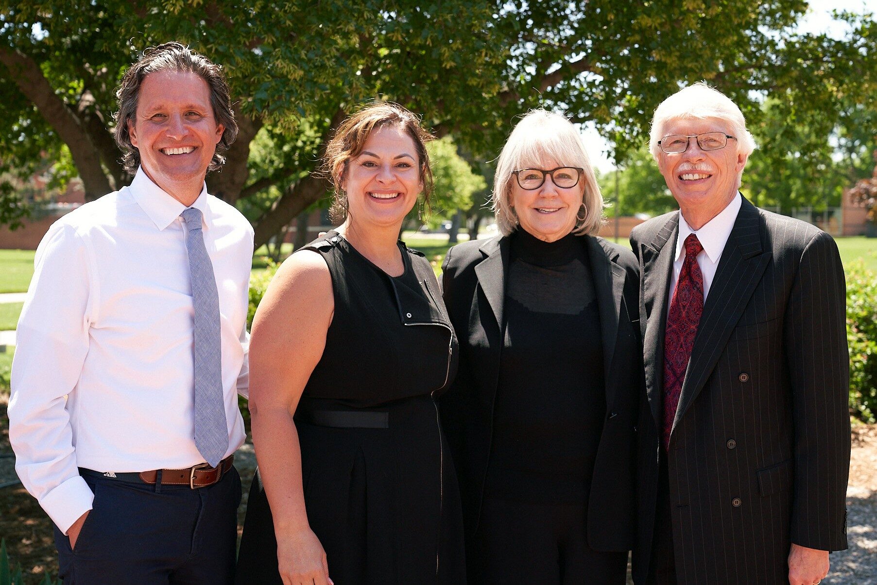 McPherson College President Michael Schneider and his wife Kandee with Melanie and Richard Lundquist at McPherson College commencement in May.