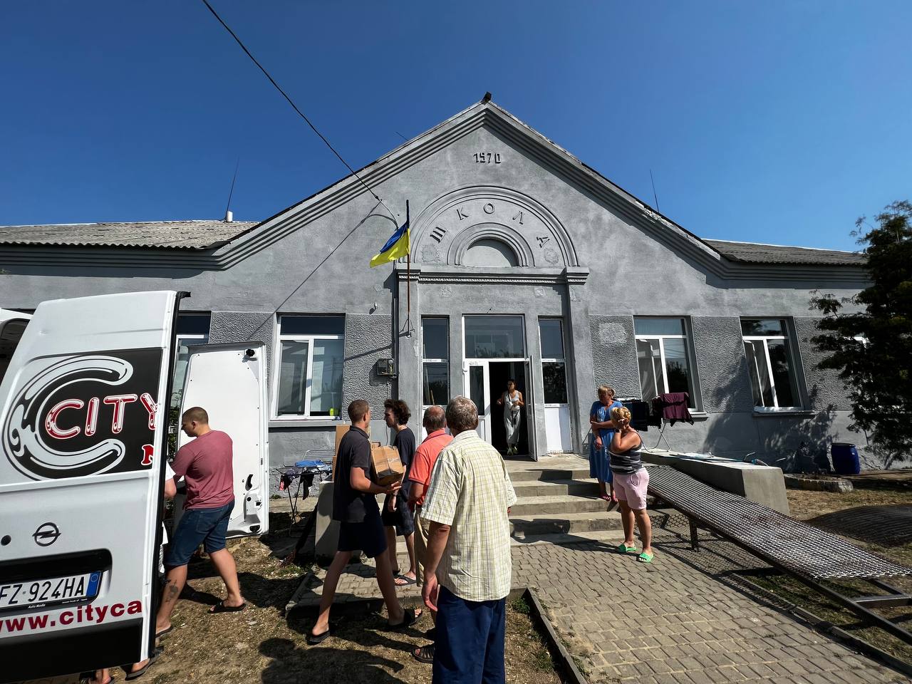 Volunteers unload supplies at a shelter in Ukraine for people fleeing the Russian invasion. The shelter was built in an abandoned schoolhouse, in part with funds from Razom for Ukraine.