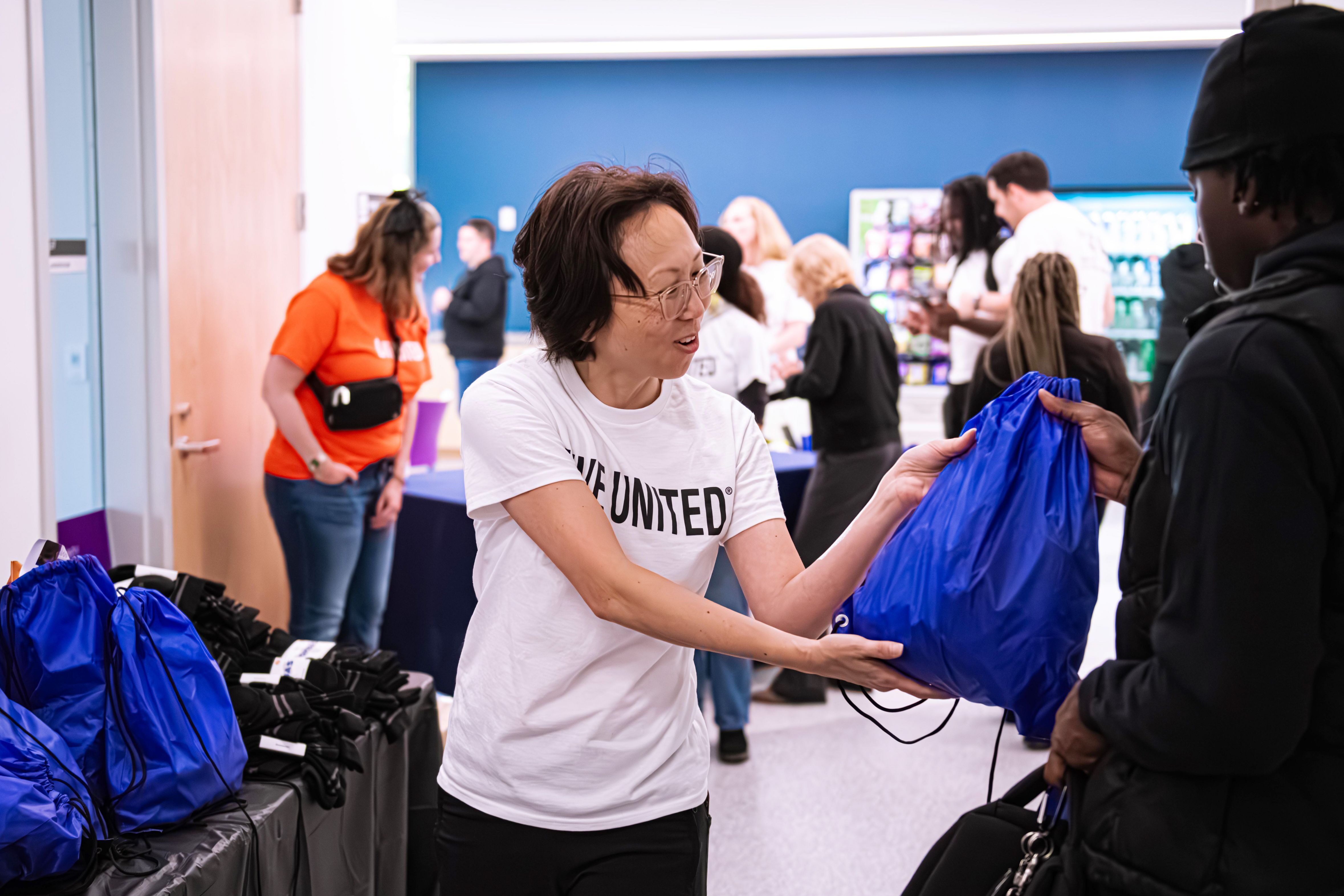 A volunteer hands out prepared supply kits during United Way of the National Capitol Area’s outreach program Project Community Connect, on Nov. 23, 2024.