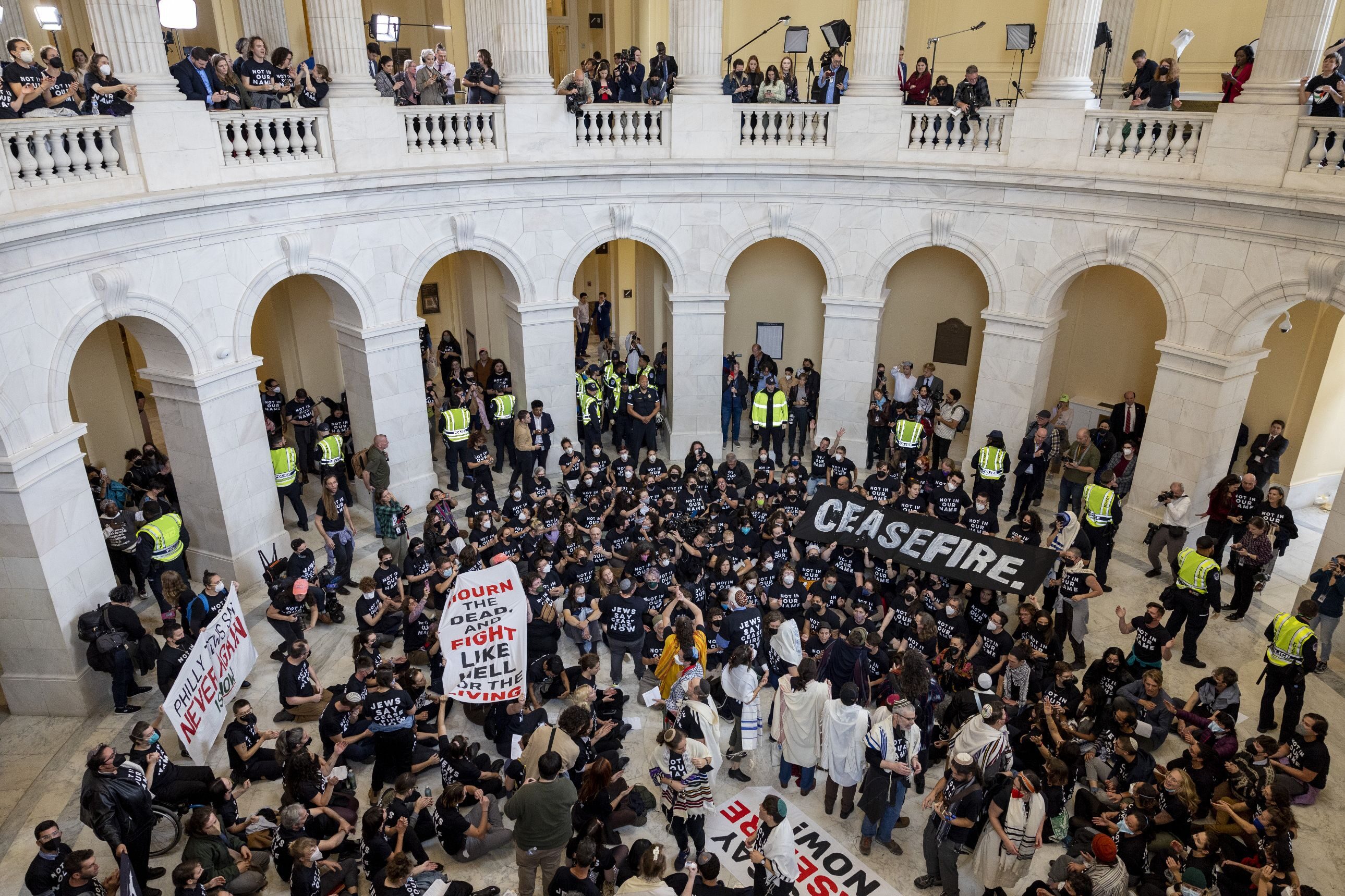 Demonstrators, calling for a ceasefire in the ongoing war between Israel and Hamas, chant and hold banners during a protest at the rotunda in the Cannon House Office Building at the Capitol in Washington, D.C., on Oct. 18, 2023.
