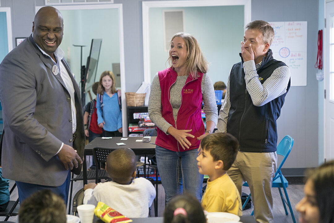 Ultimately, what charities do with corporate gifts is just as important as how much companies give, says Rodney Bullard, left, executive director of the Chick- Fil-A Foundation. Here, he announces a surprise $100,000 grant for the Path Project, which serves children who live in mobile homes.