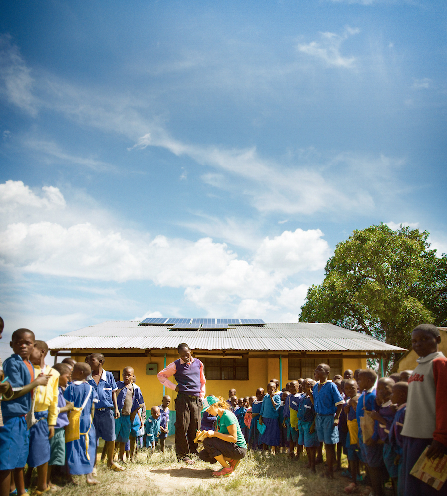SolarCity photovoltaic designer Alex Webster explains solar energy to students at Kulumbeni Primary School in Matate, Kenya.