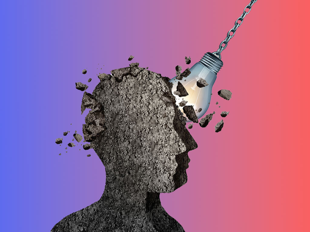 A wrecking ball smashes a head made of stone on a background gradient from blue to red. 