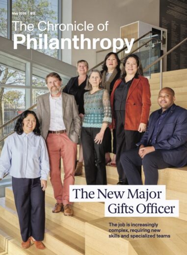 A mix of men and women from different ages to races stand on a stairwell as the issue covers the new major gifts officer