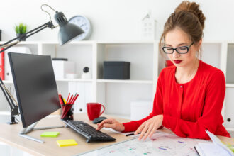 Woman sits at her desk working on small shop fundraising