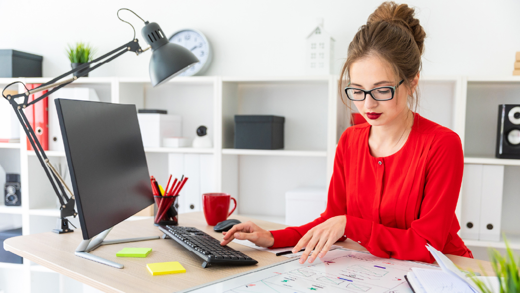 Woman sits at her desk working on small shop fundraising