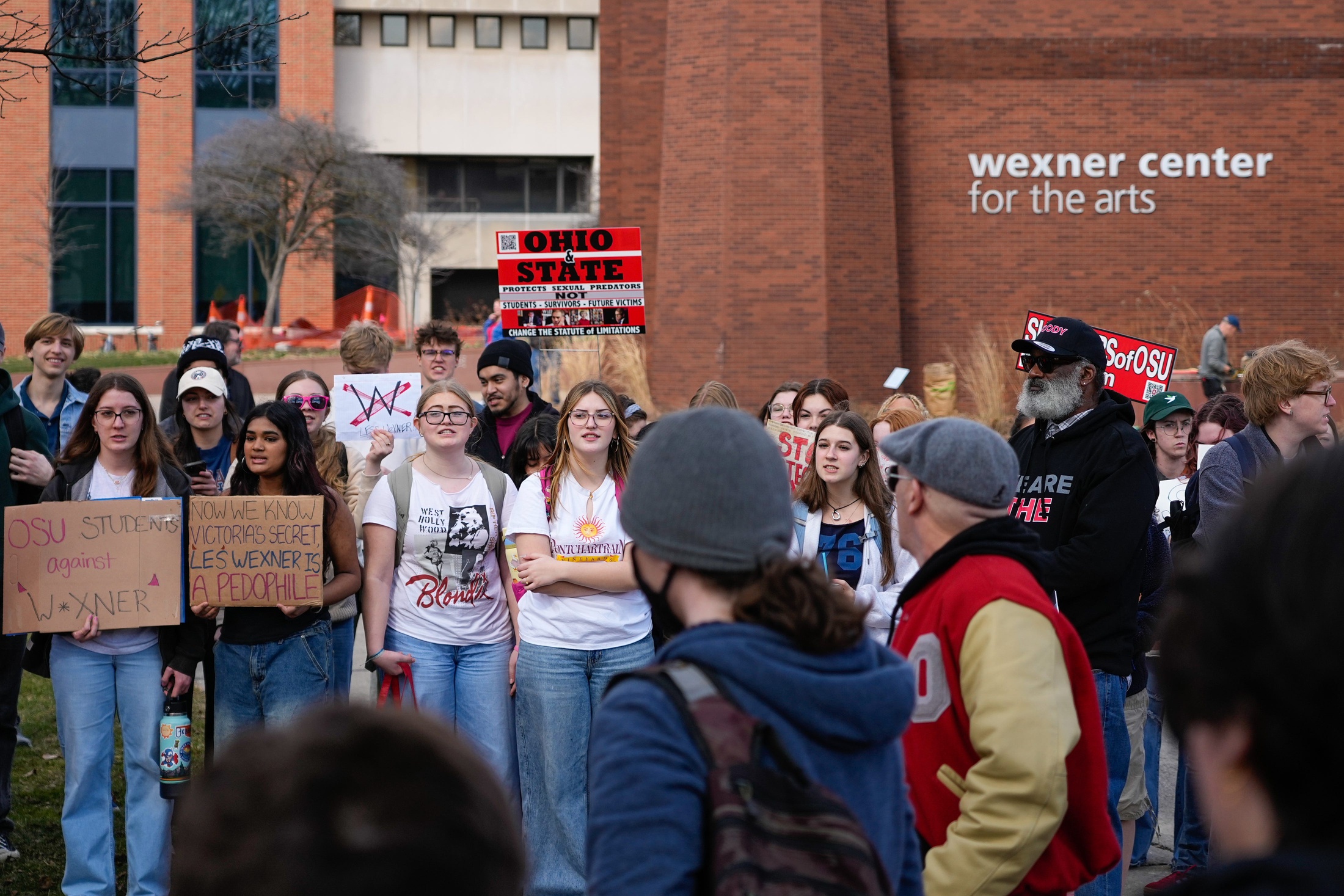 People protest Les Wexner outside the Wexner Center for the Arts on the campus of Ohio State University on Friday, Feb. 27, 2026 in Columbus, Ohio.