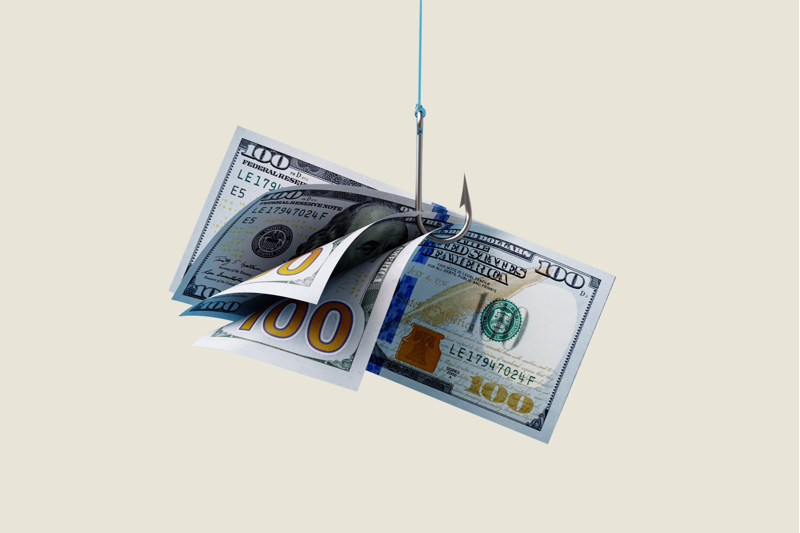 Several one-hundred dollar bills hang from a fish hook.