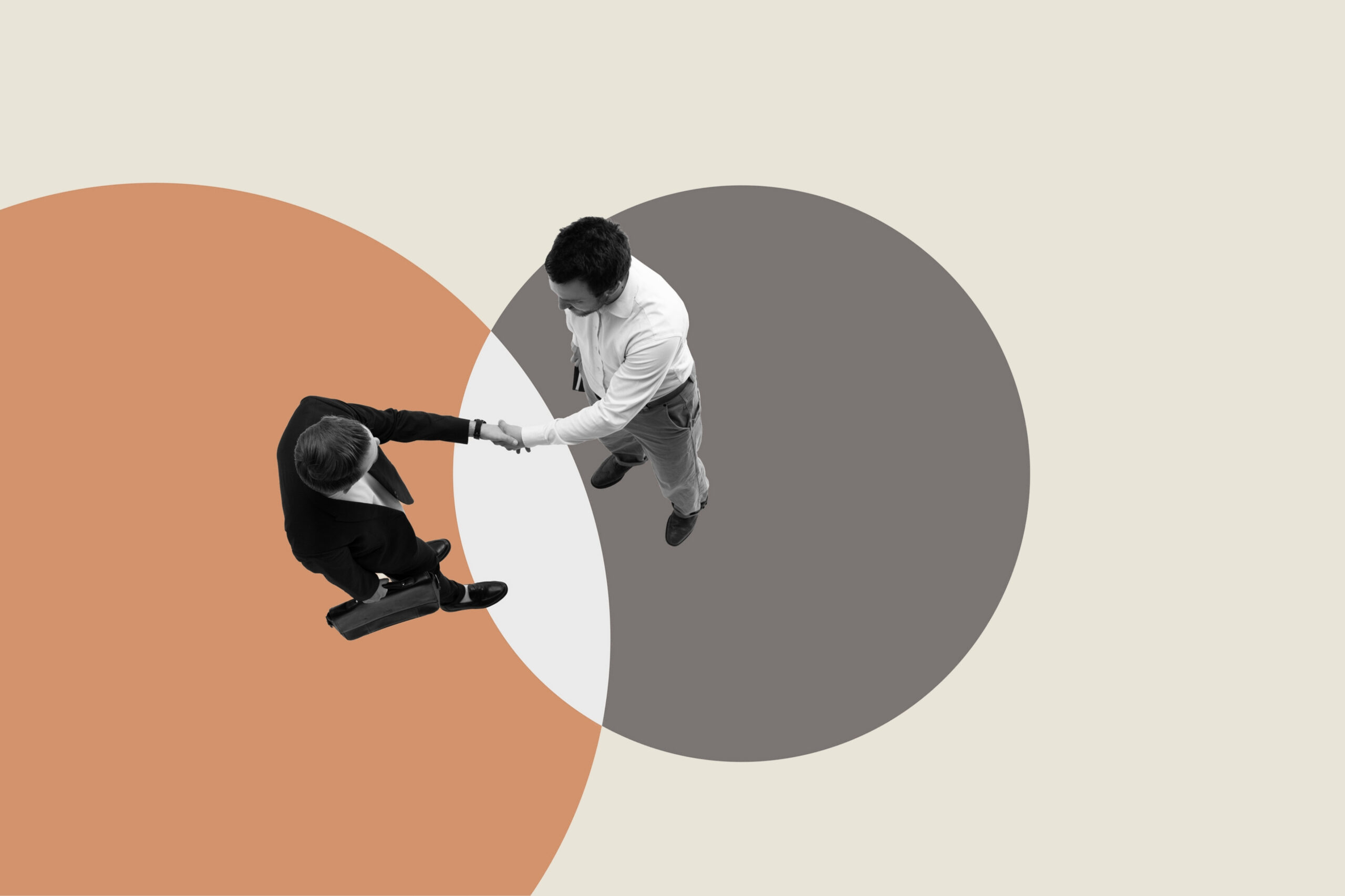 Overhead view of two business men shaking hands.